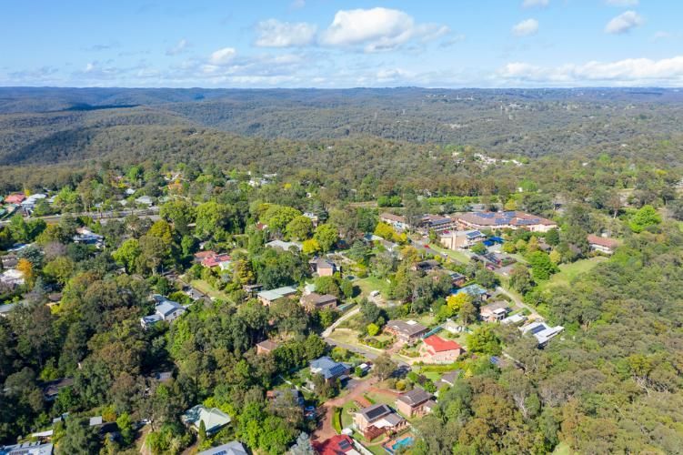 An Aerial View of a Residential Area Surrounded by Trees and Houses — Bonanno's Menswear in Engadine, NSW