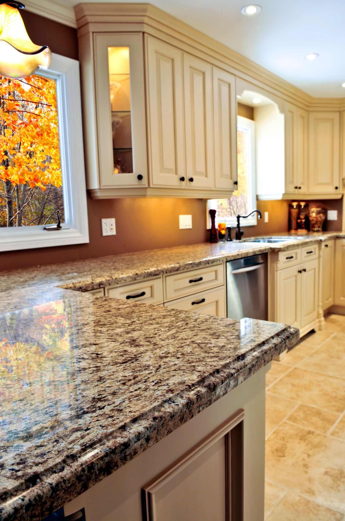 A kitchen with granite counter tops and white cabinets