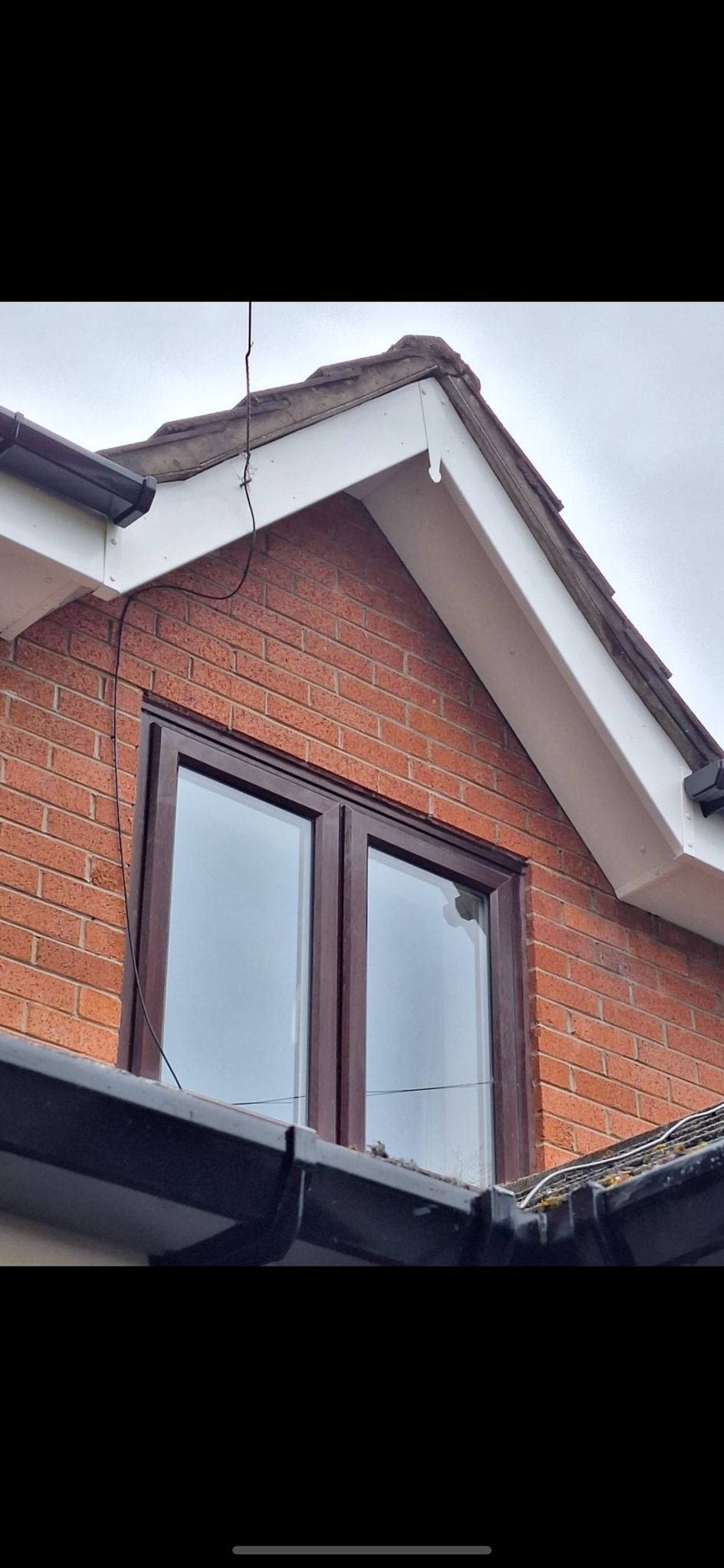 A picture of new barge boards and soffits on a property