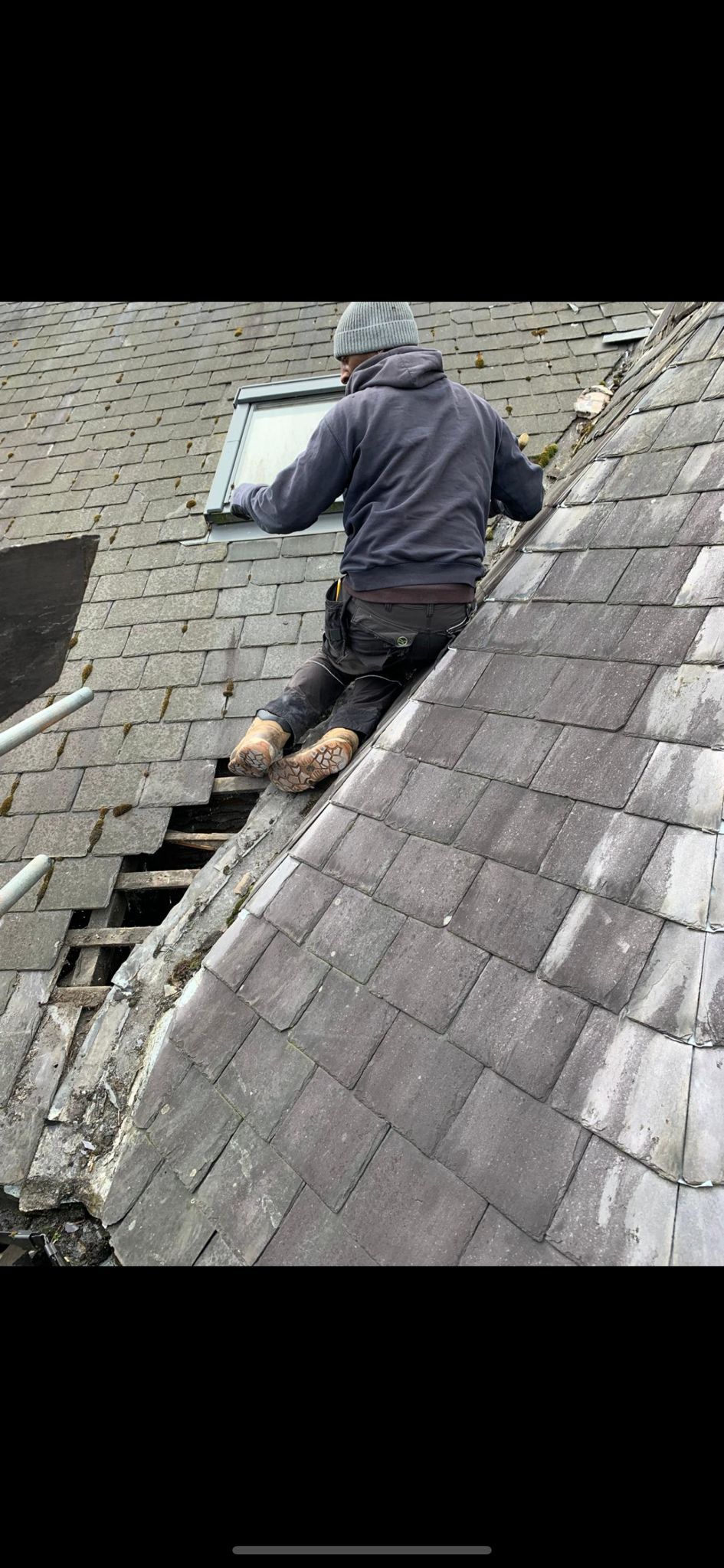 A picture of the Manchester Roofing Repairs Team carrying out  a Slate Roof Repair
