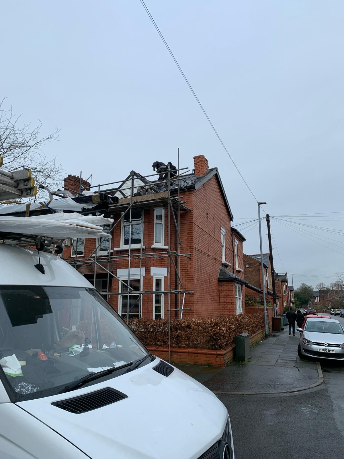 A picture of a gable roof being replaced