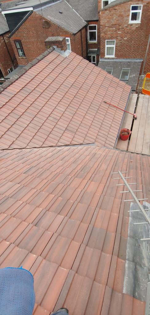 a picture of a new roof with valley gutter installed by Roofers Manchester