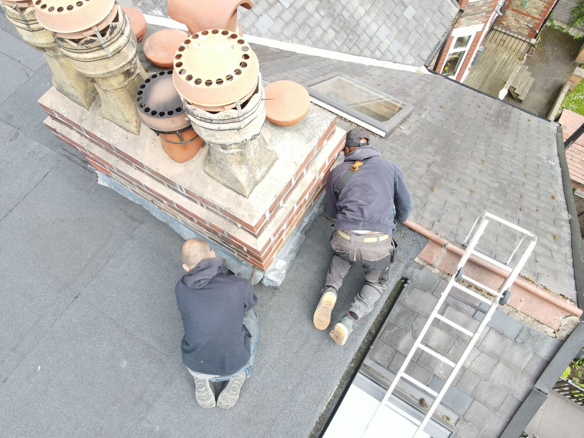 a picture of a chimney repair being carried out by Roofers Manchester