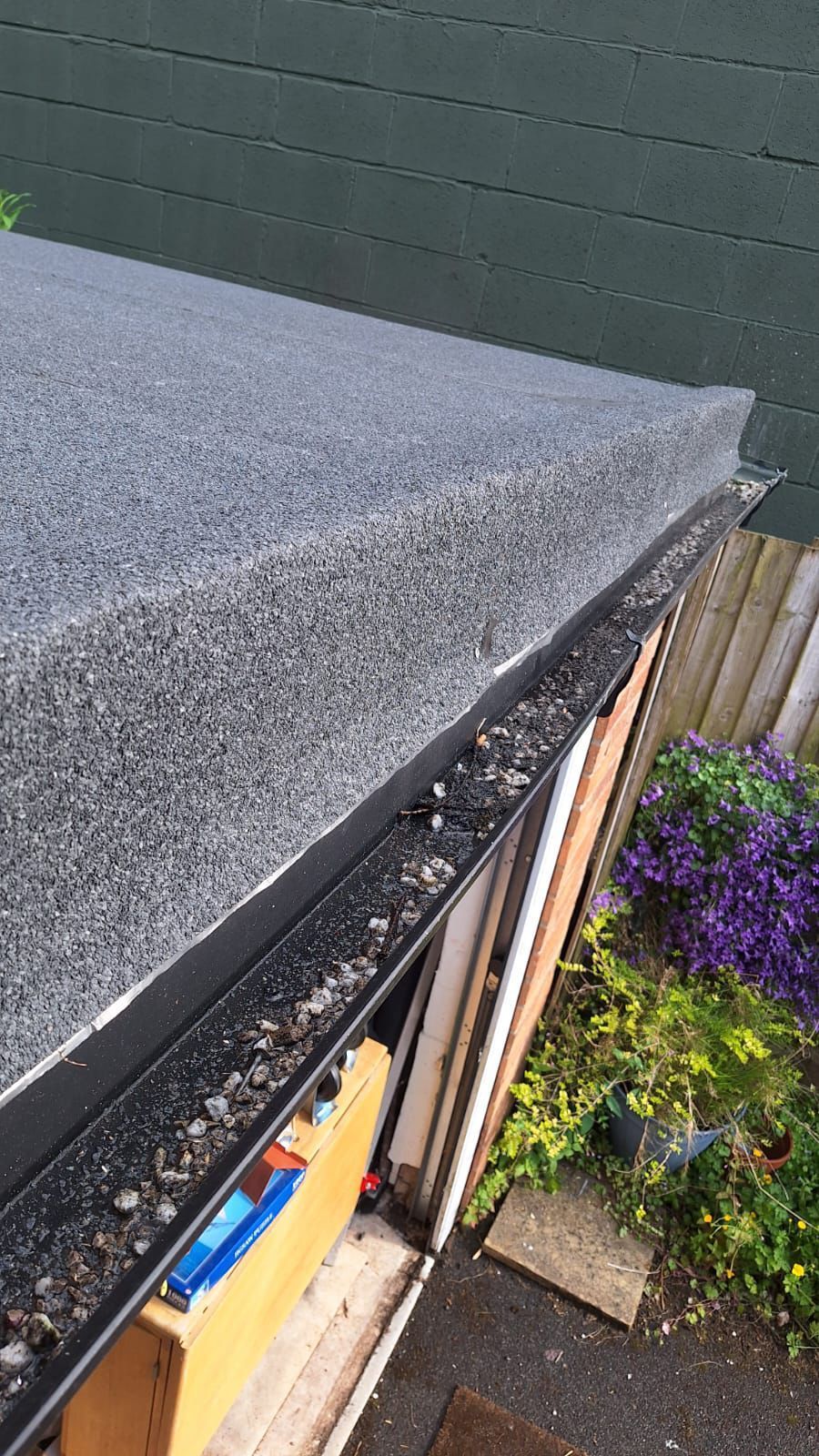 A close up of a roof with a gutter on it.