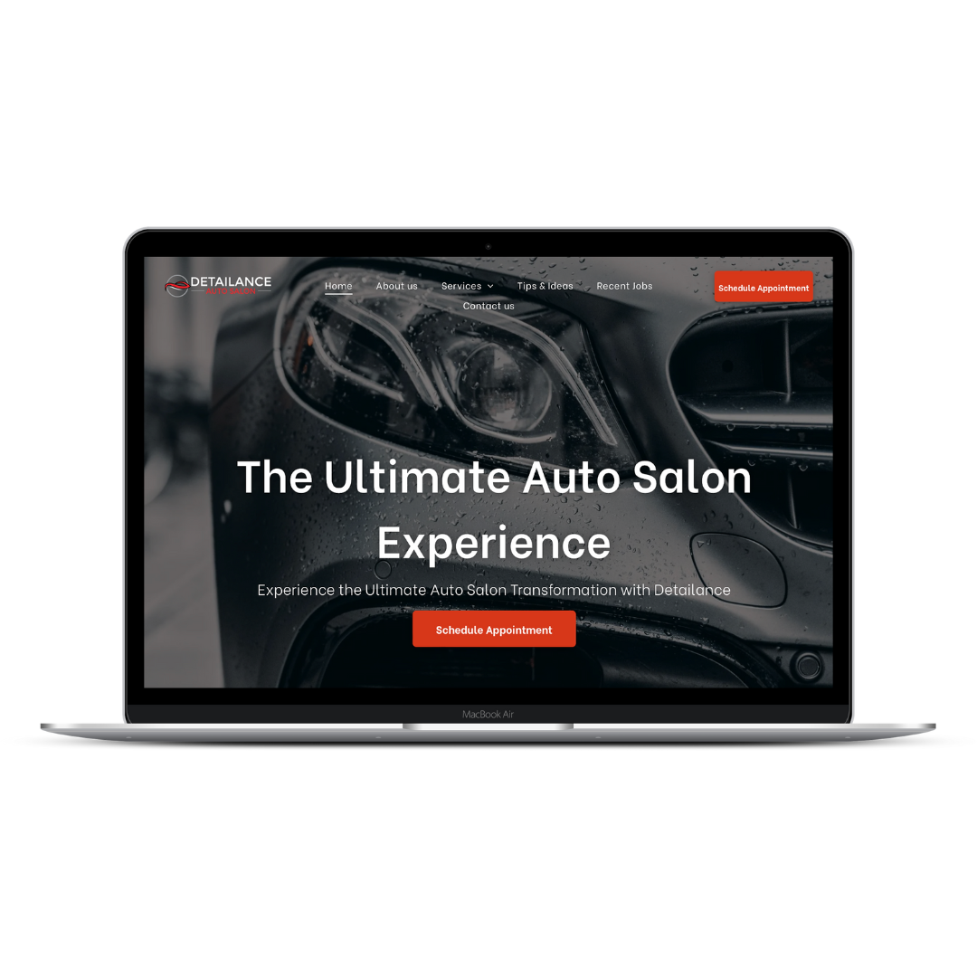 A laptop screen displaying a website with a close-up photo of a black car and the text 