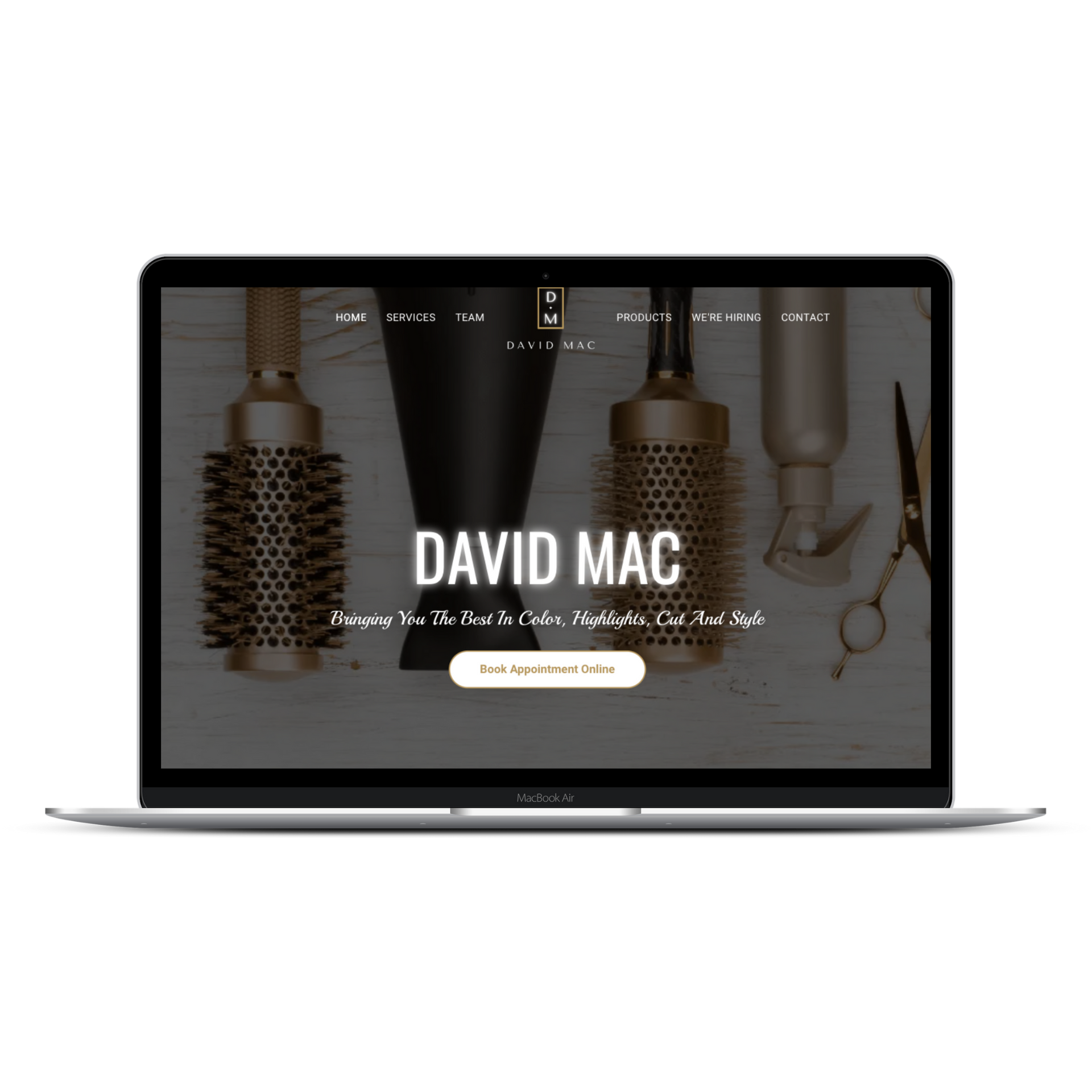 A laptop displaying the David Mac salon website homepage with hair styling tools in the background.