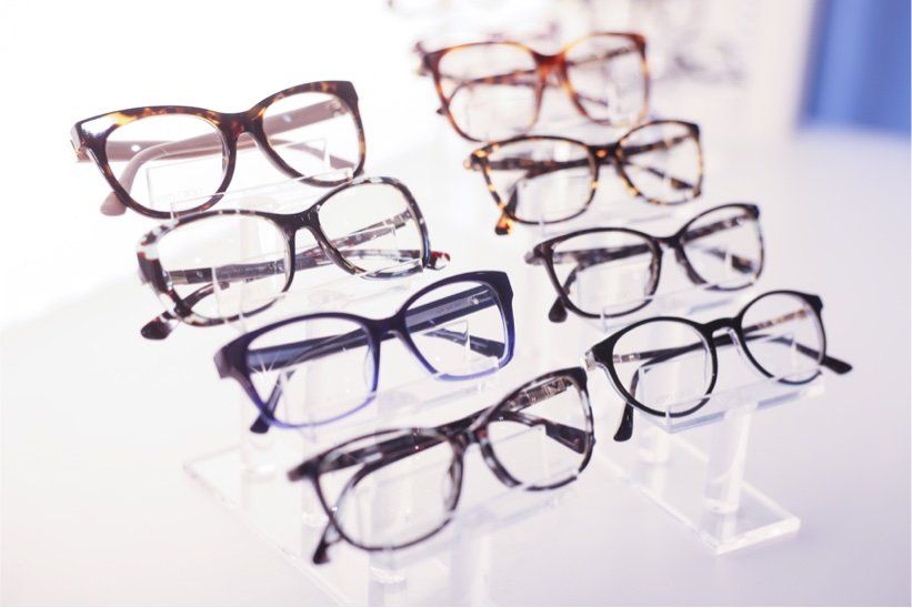 A bunch of glasses are sitting on top of each other on a table.