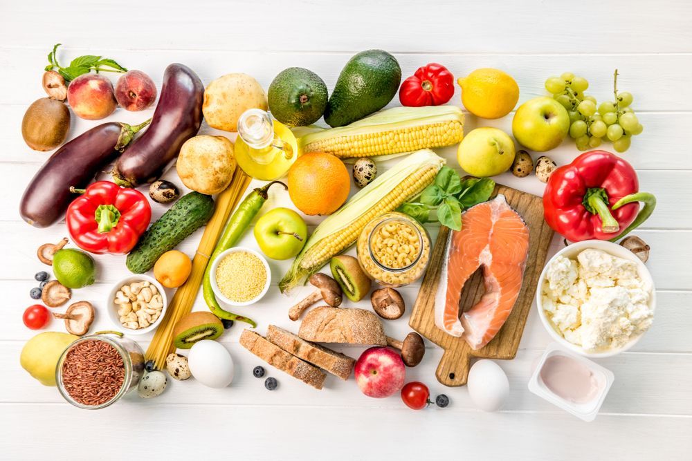 There are many different types of fruits and vegetables on the table.