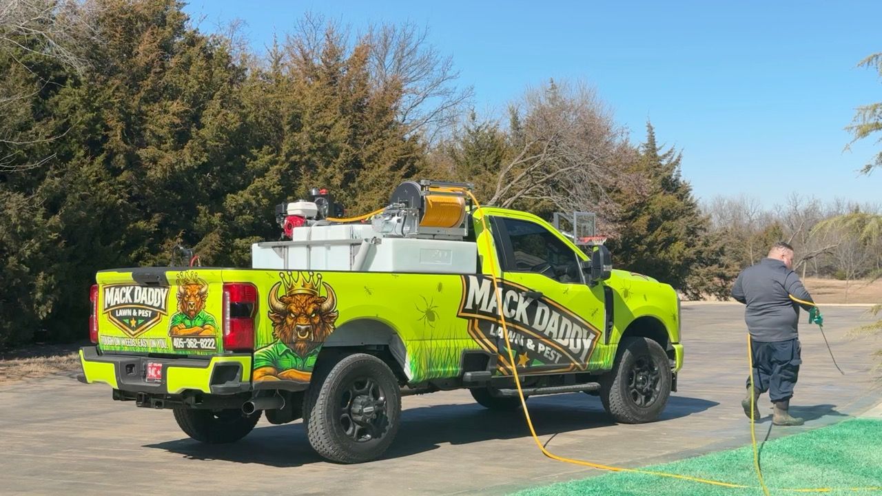 Green truck with logo spraying lawn; person spraying with hose.