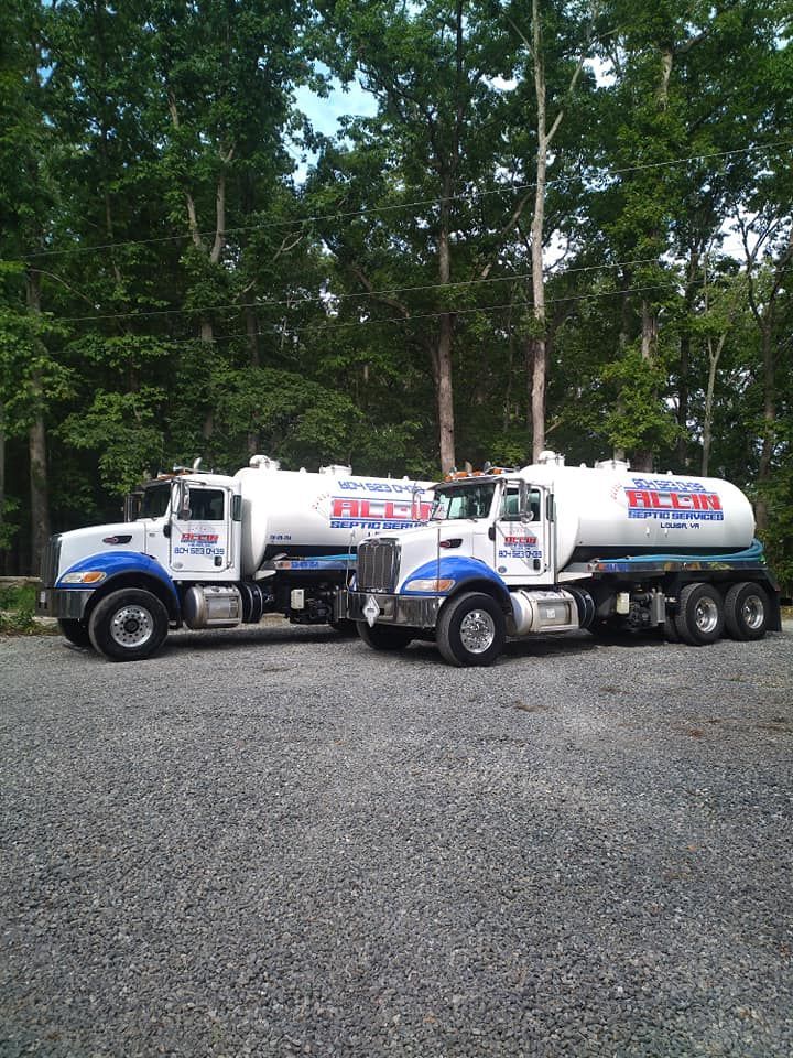 Two white fuel tanker trucks branded with