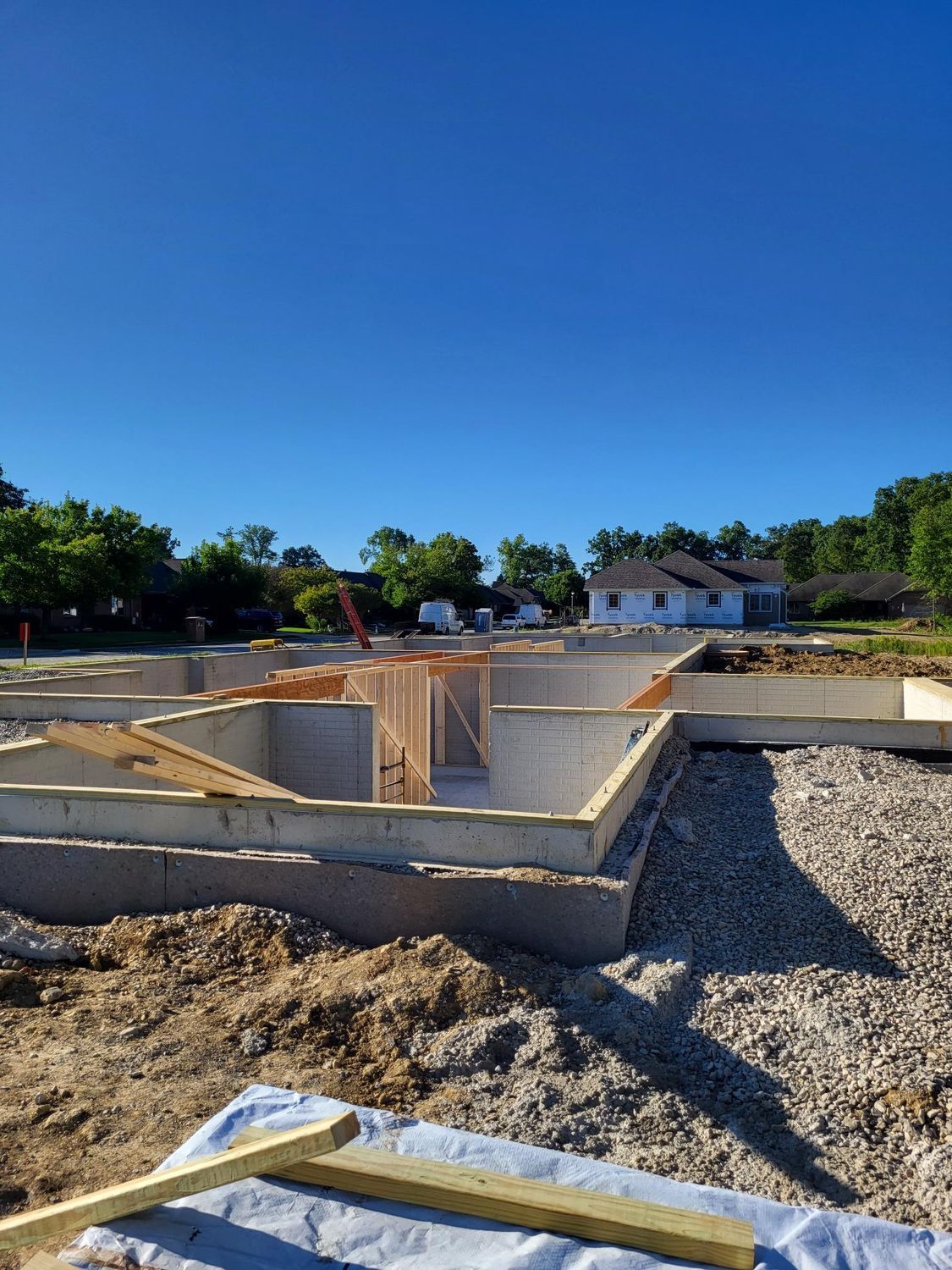 The foundation of a house is being built on a sunny day.