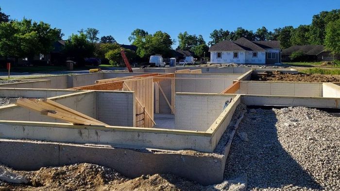 A house is being built with a concrete foundation