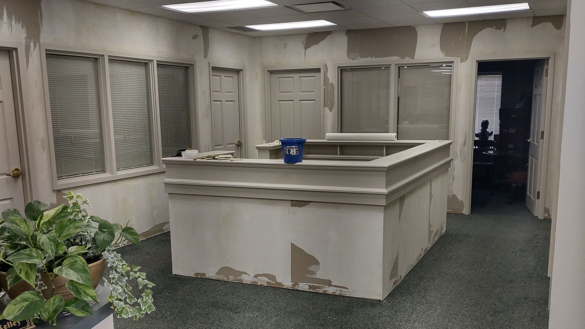 An empty office with a bucket of water on the counter