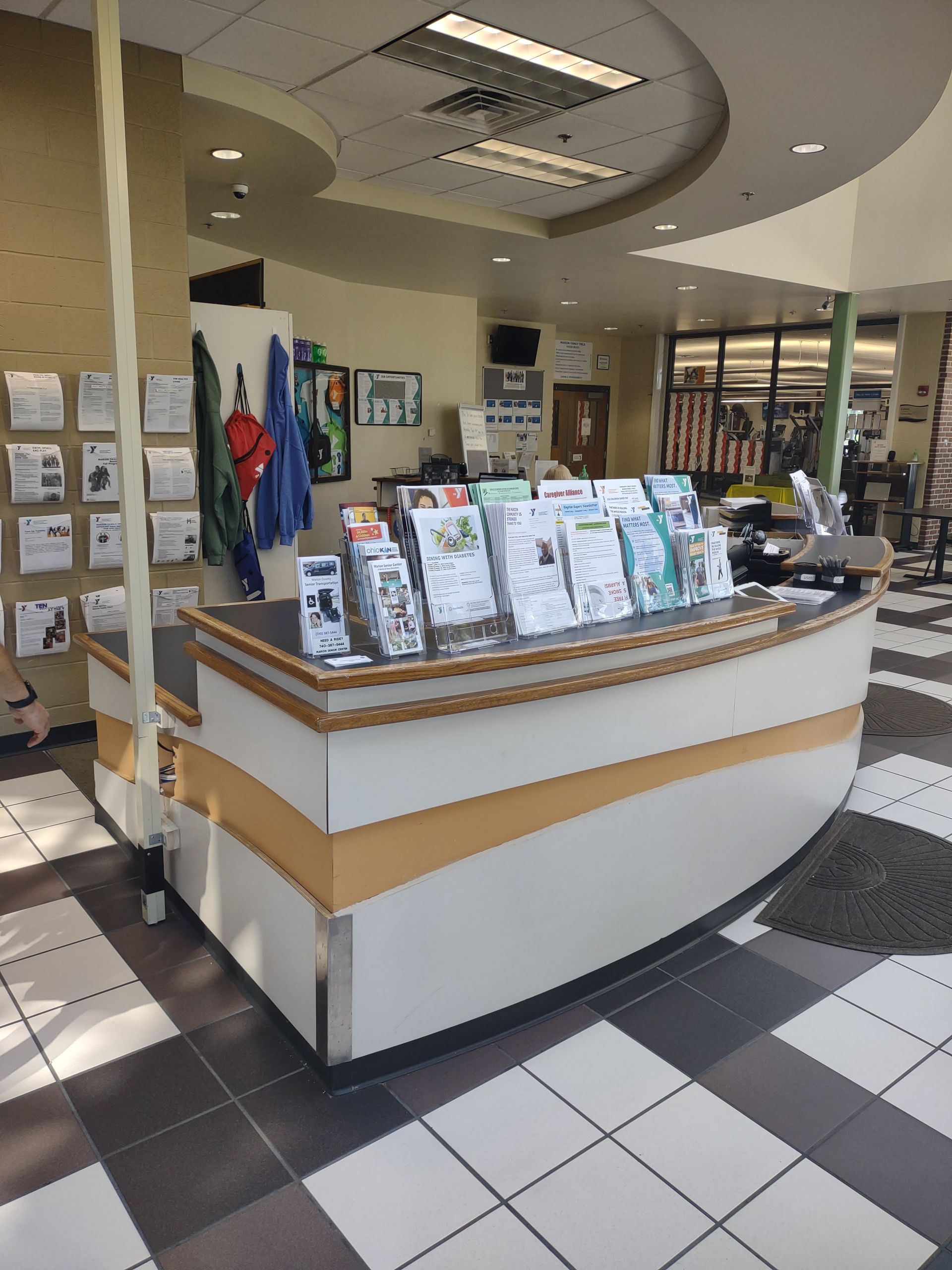 A counter in a library with a lot of books on it
