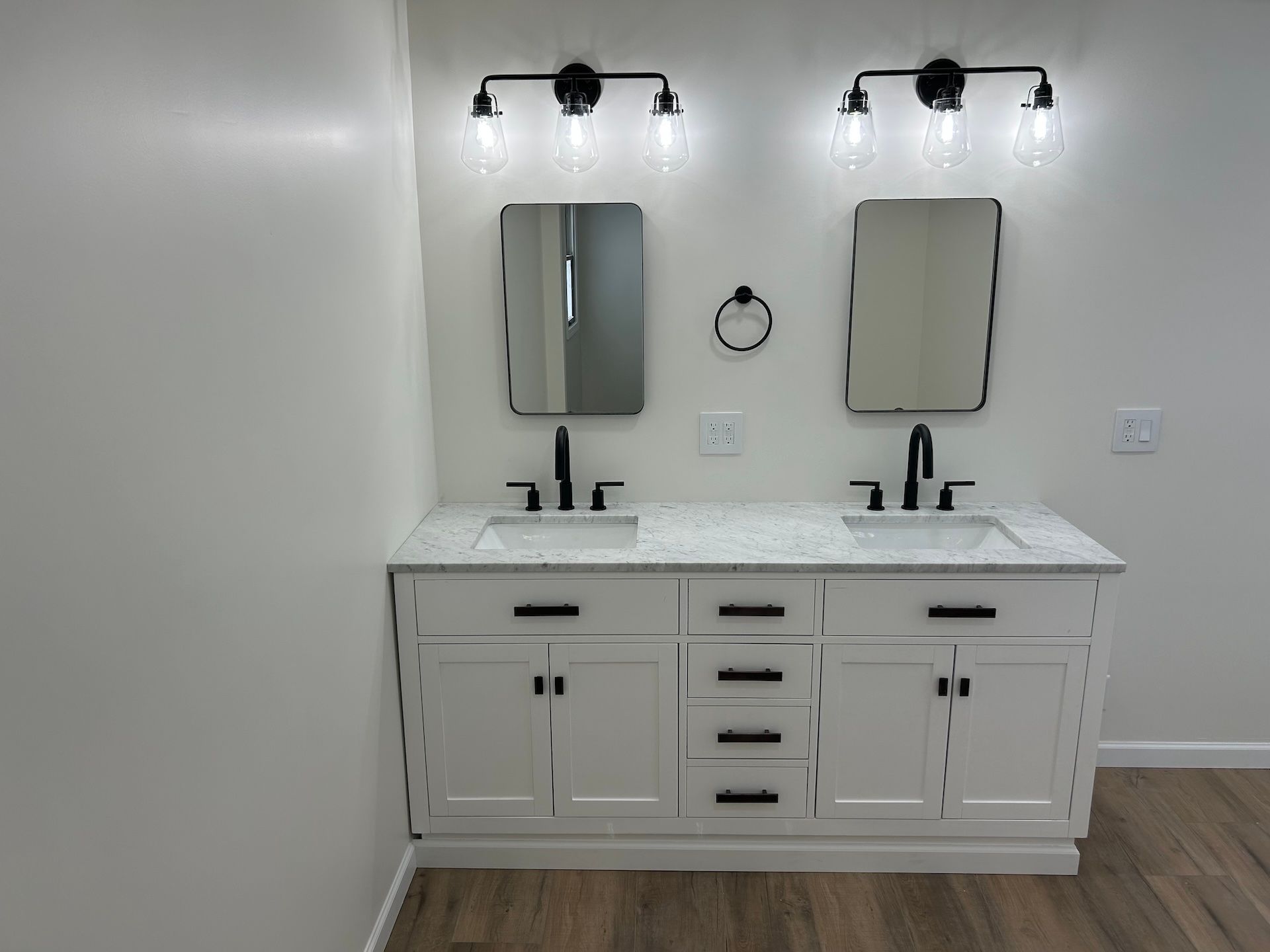 A bathroom with two sinks and two mirrors.