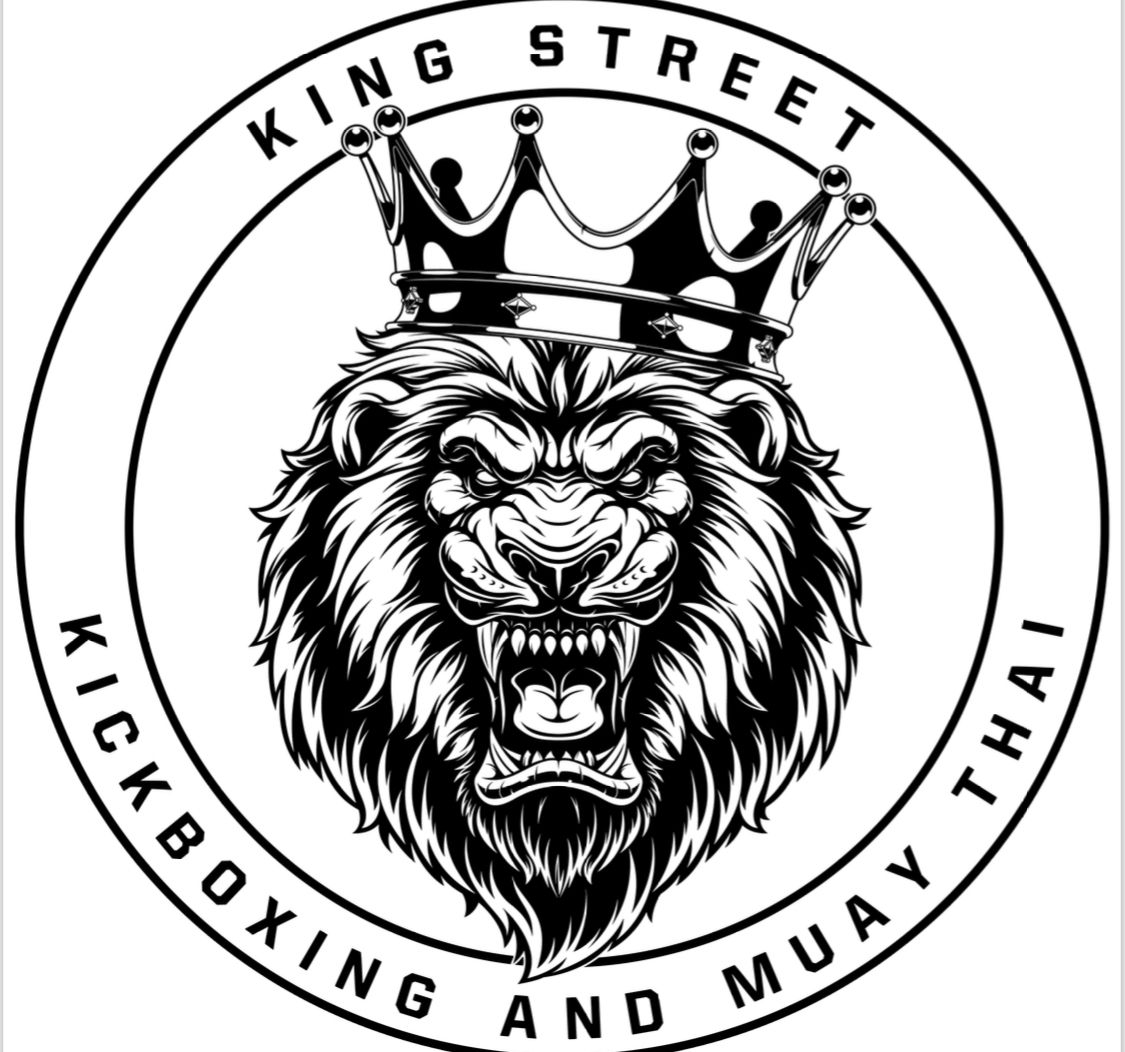A black and white logo for king street kickboxing and muay thai with a lion wearing a crown.
