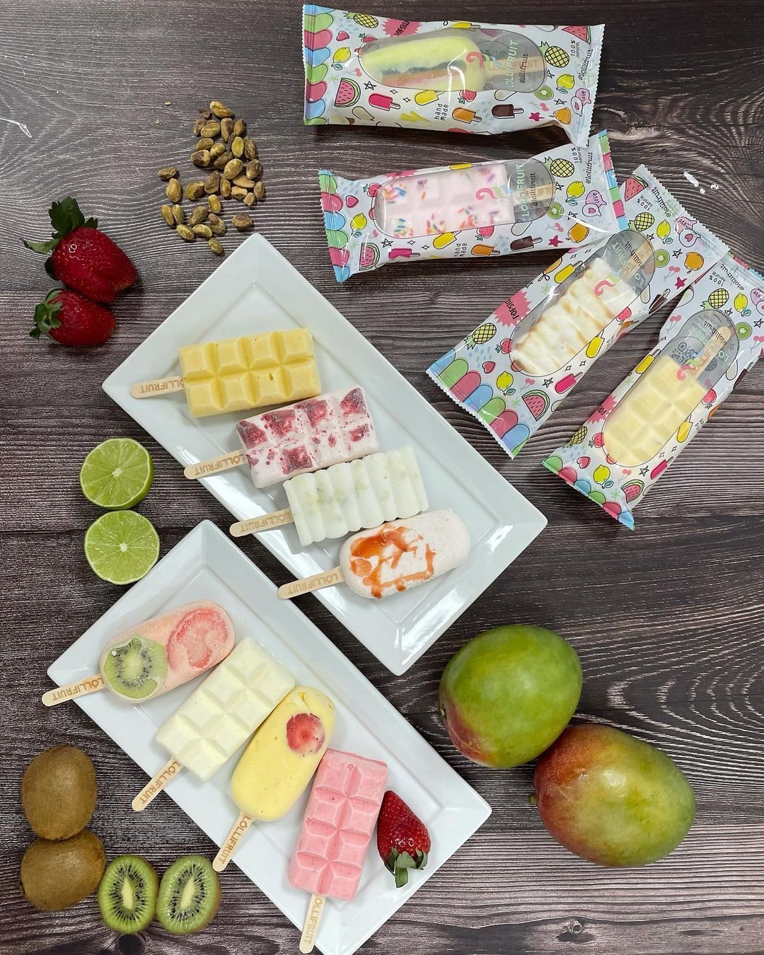 A table topped with plates of ice cream and fruit.