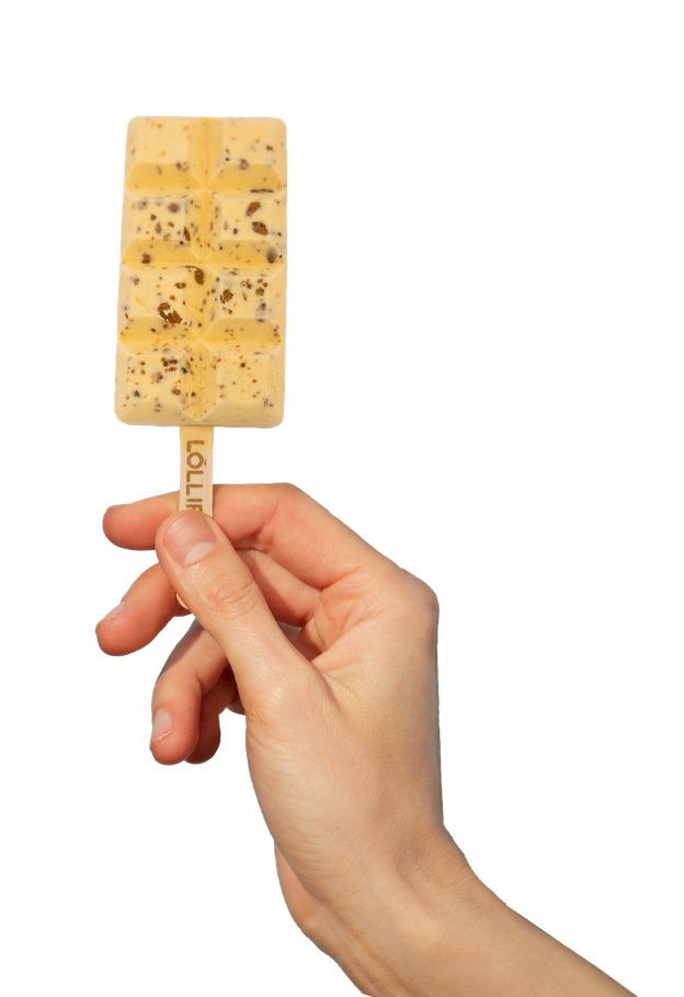 A hand is holding an ice cream bar on a stick.
