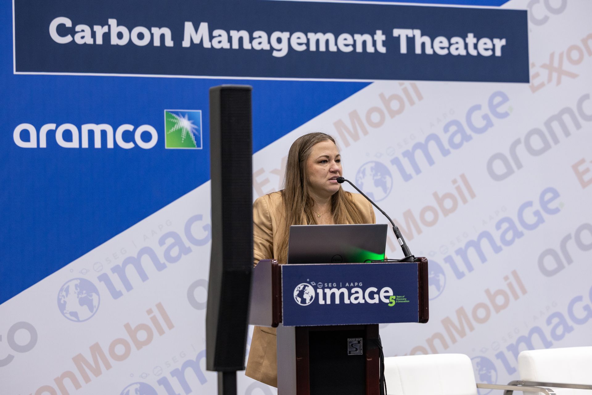 A woman speaking at a podium in a