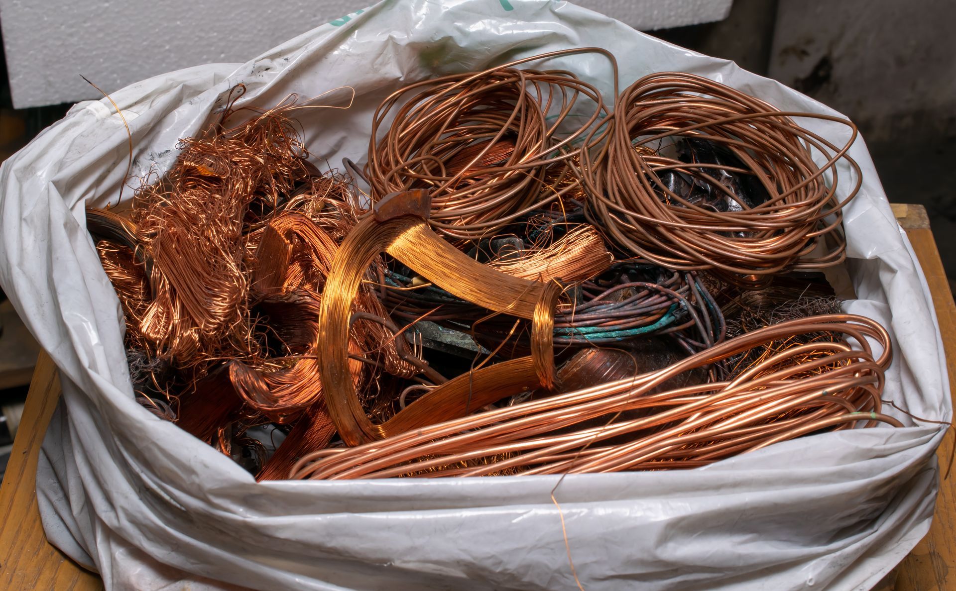 A white plastic bag filled with copper wires