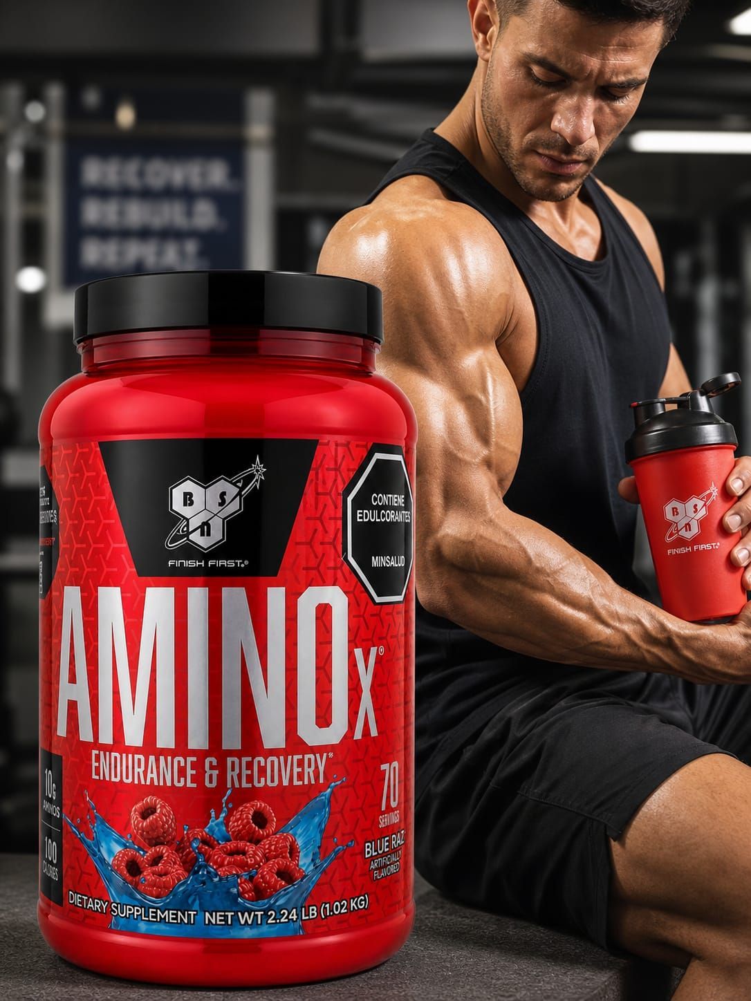 Frasco rojo de suplemento AminoX con tapa negra y dibujos de frutas en la etiqueta.