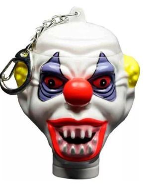 Linterna colgante blanca con cara de payaso, nariz roja, ojos amarillos y llavero metálico.