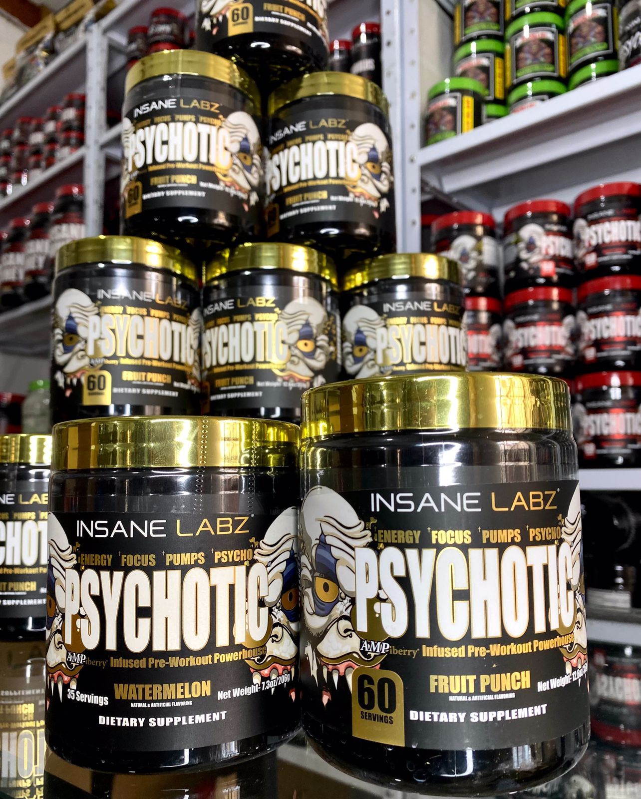 Frasco negro del suplemento dietético Insane Labz Psychotic Fruit Punch con tapa amarilla y etiqueta llamativa.