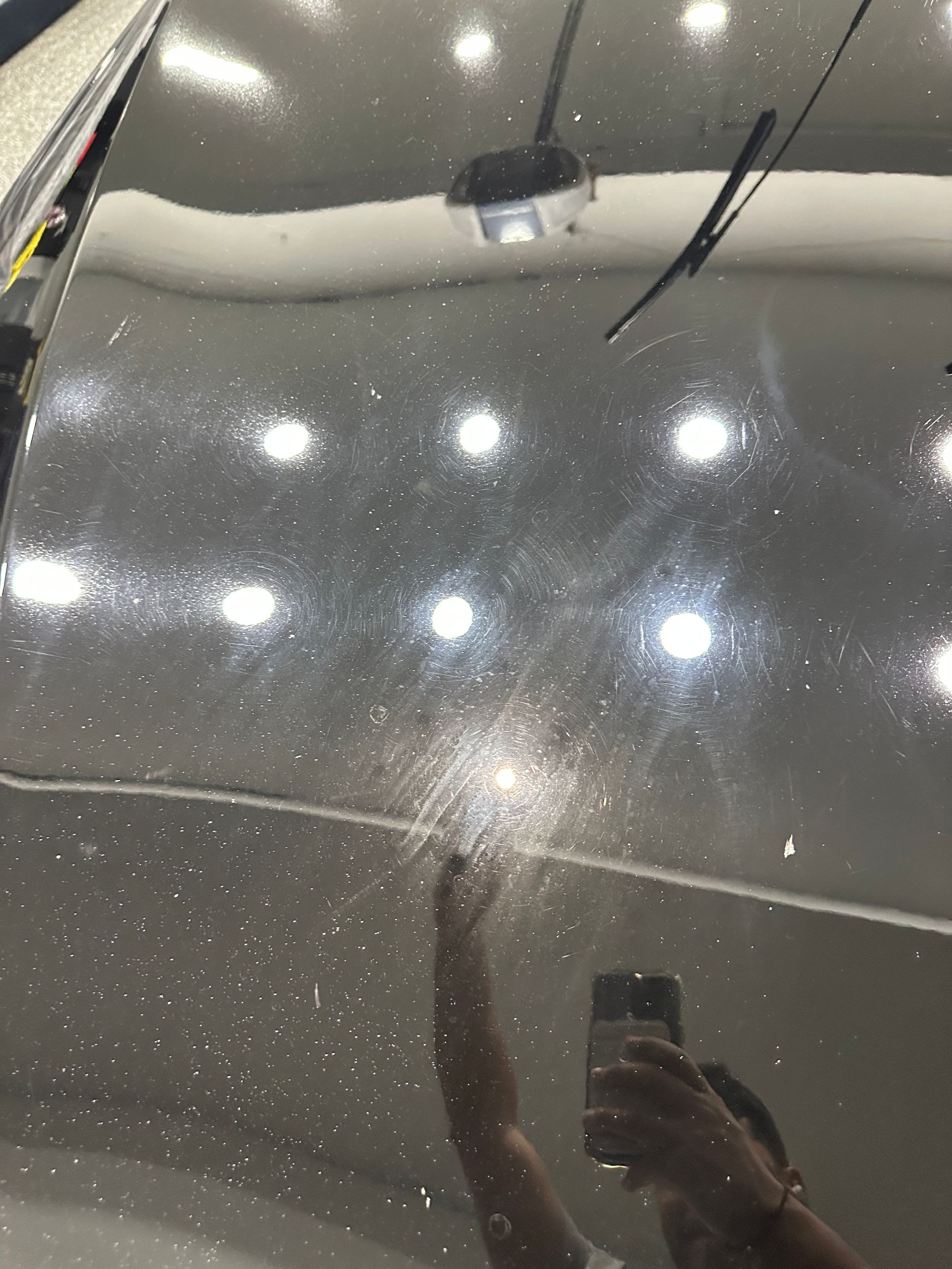 Before: Dark sedan with swirl marks
