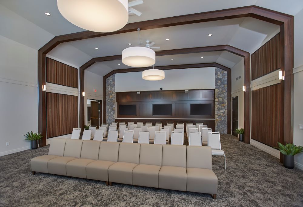 A large room with a couch and chairs in it