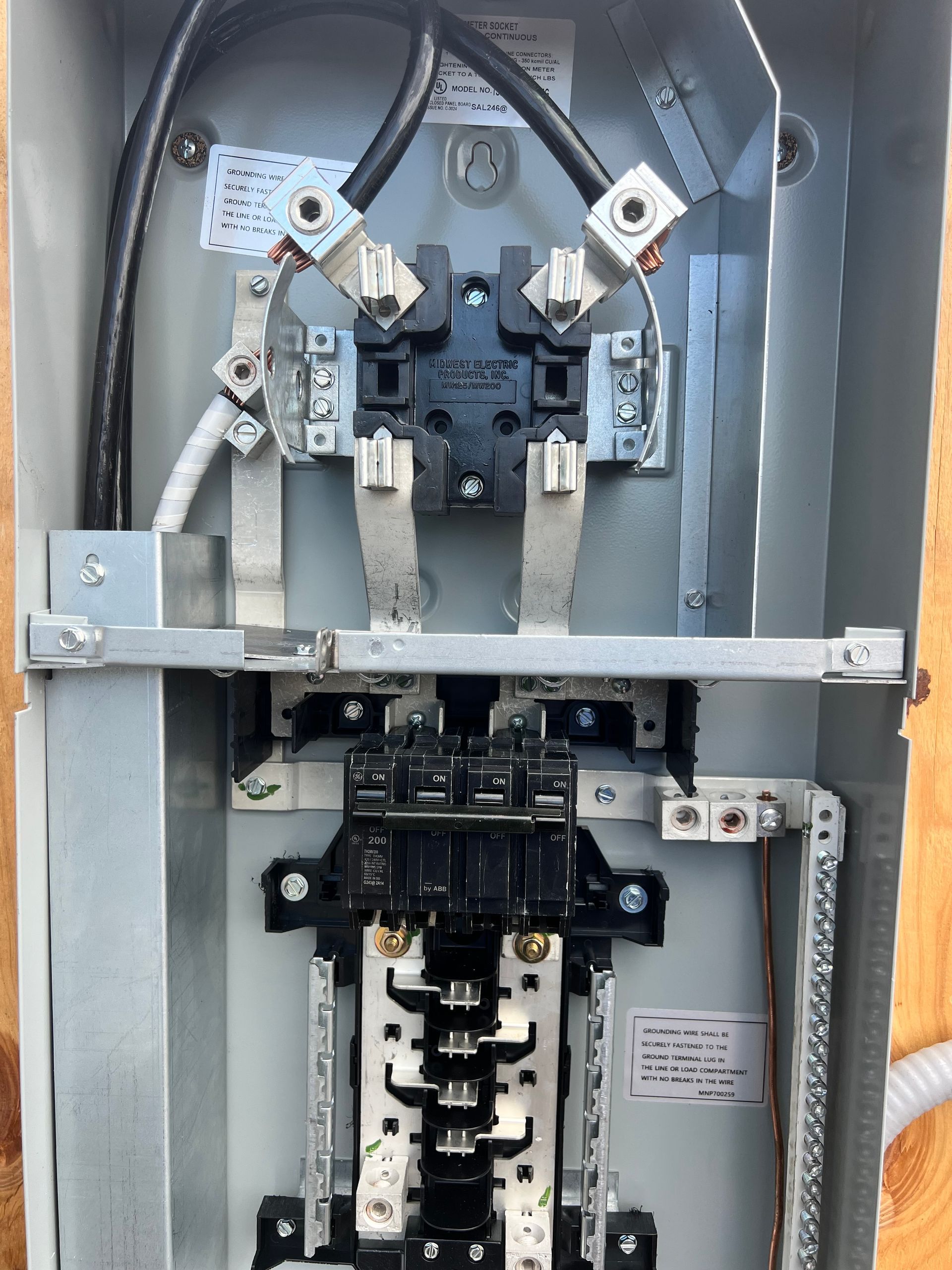 Electrical panel with wires and circuit breakers.