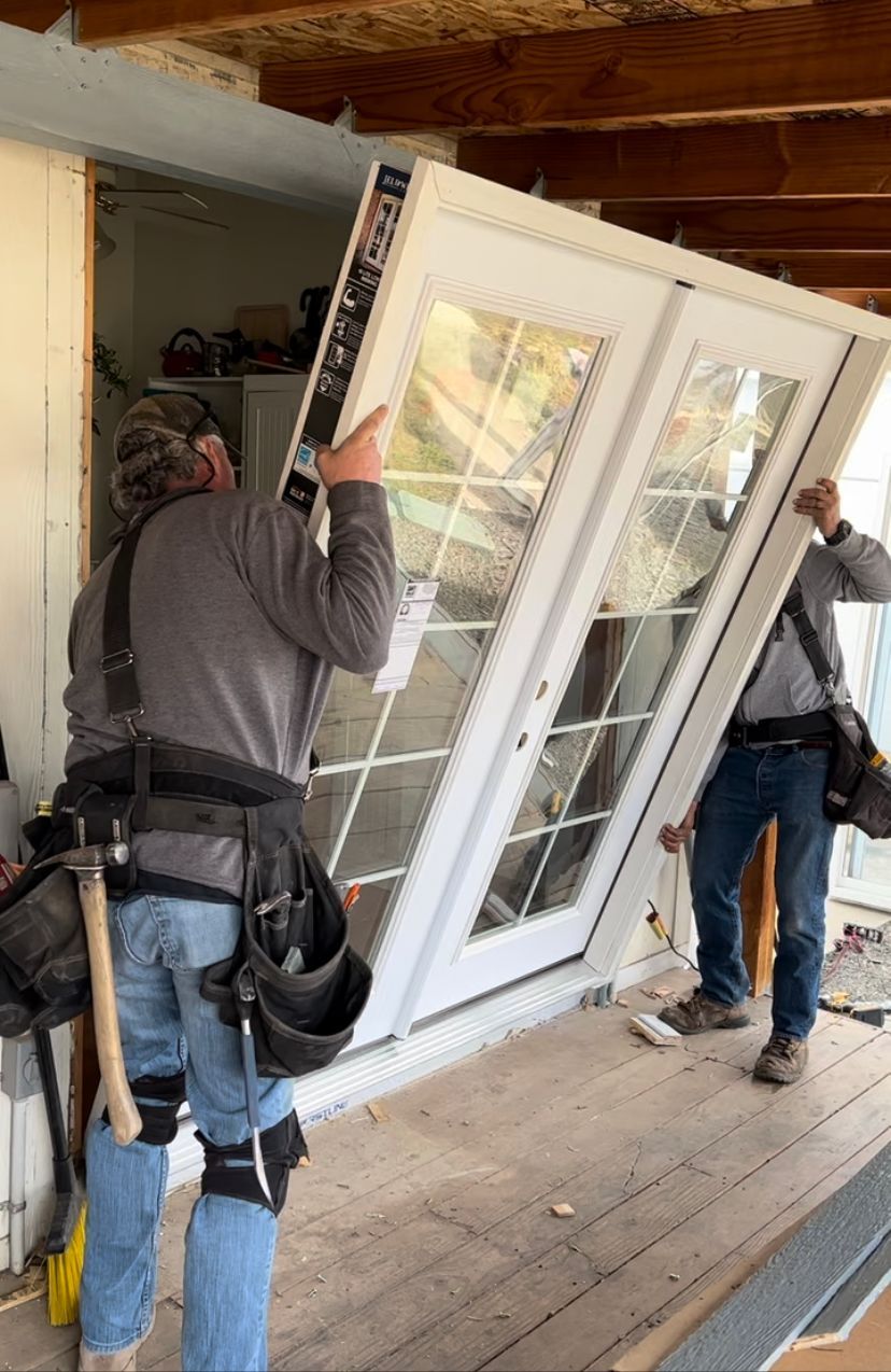 Technician installing a new front door for residential remodeling.