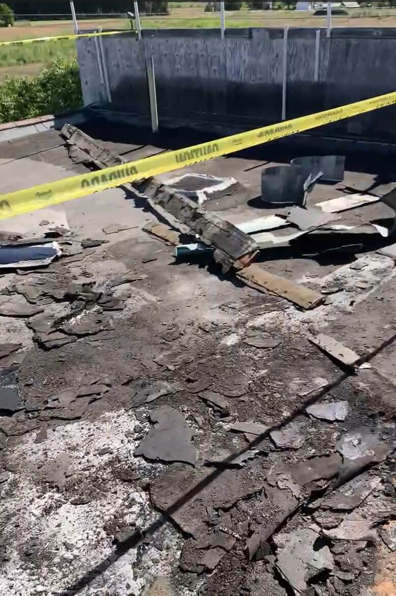 Ongoing roof tear-off at Naches Fruit Stand in Naches, WA, showcasing removed roofing layers and cleaned surface.