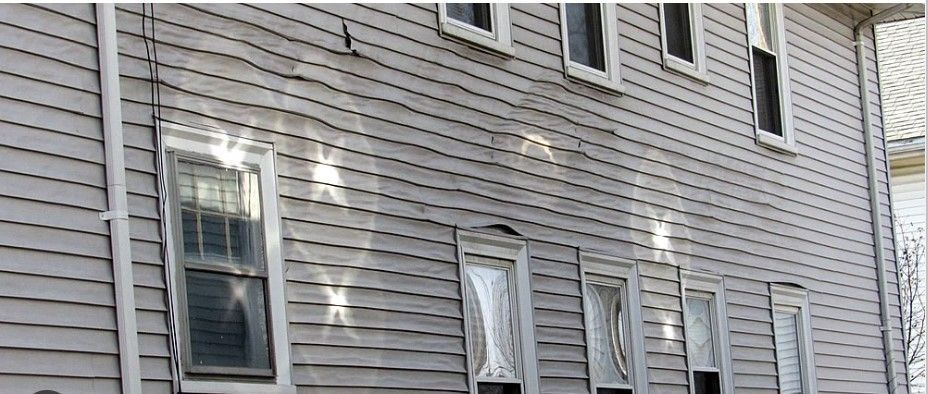 A photo showing how neighbors windows can cause hot spots by reflecting the sun and causing damage to siding