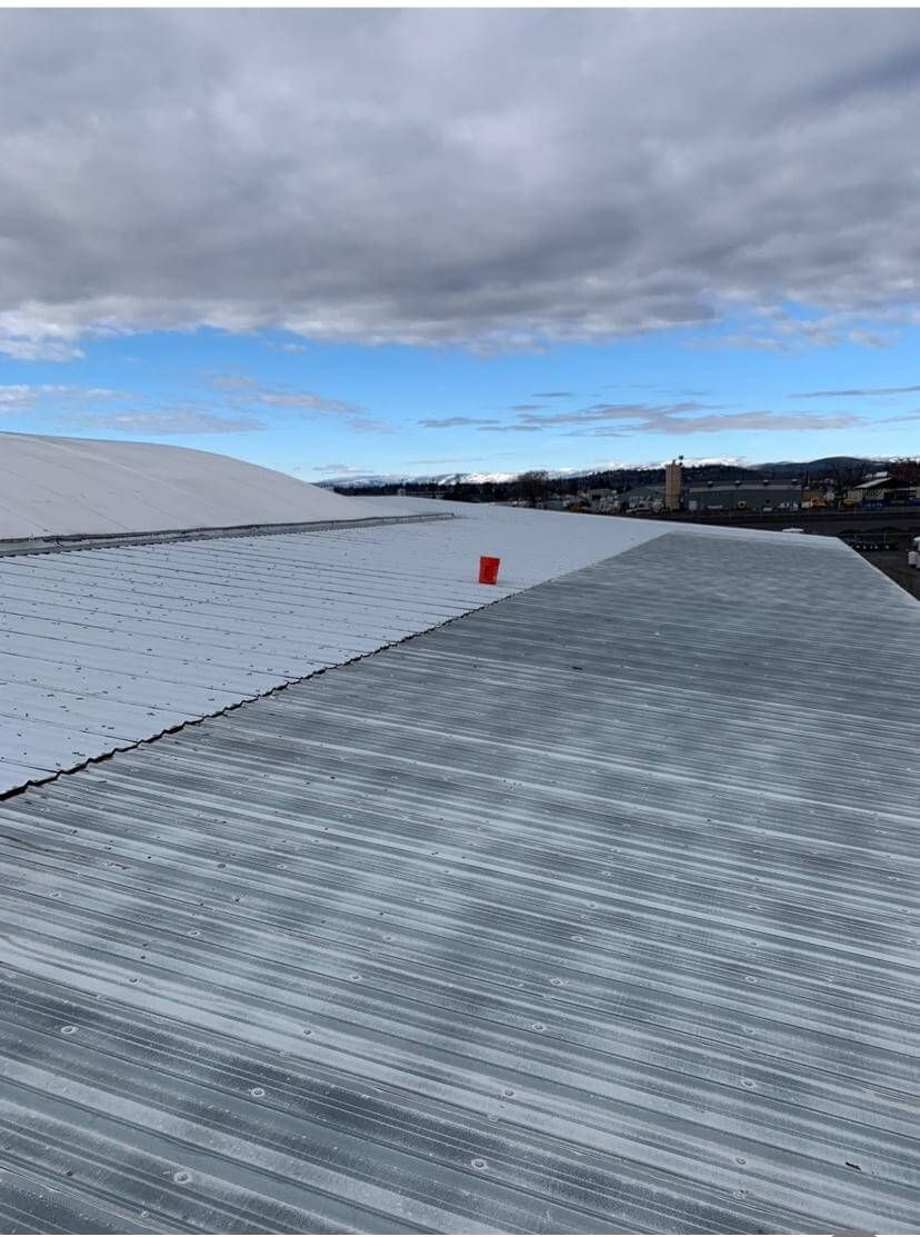 Metal roof removal in progress at Decco USA in Yakima, WA, by Yakima Roofing & Remodeling.