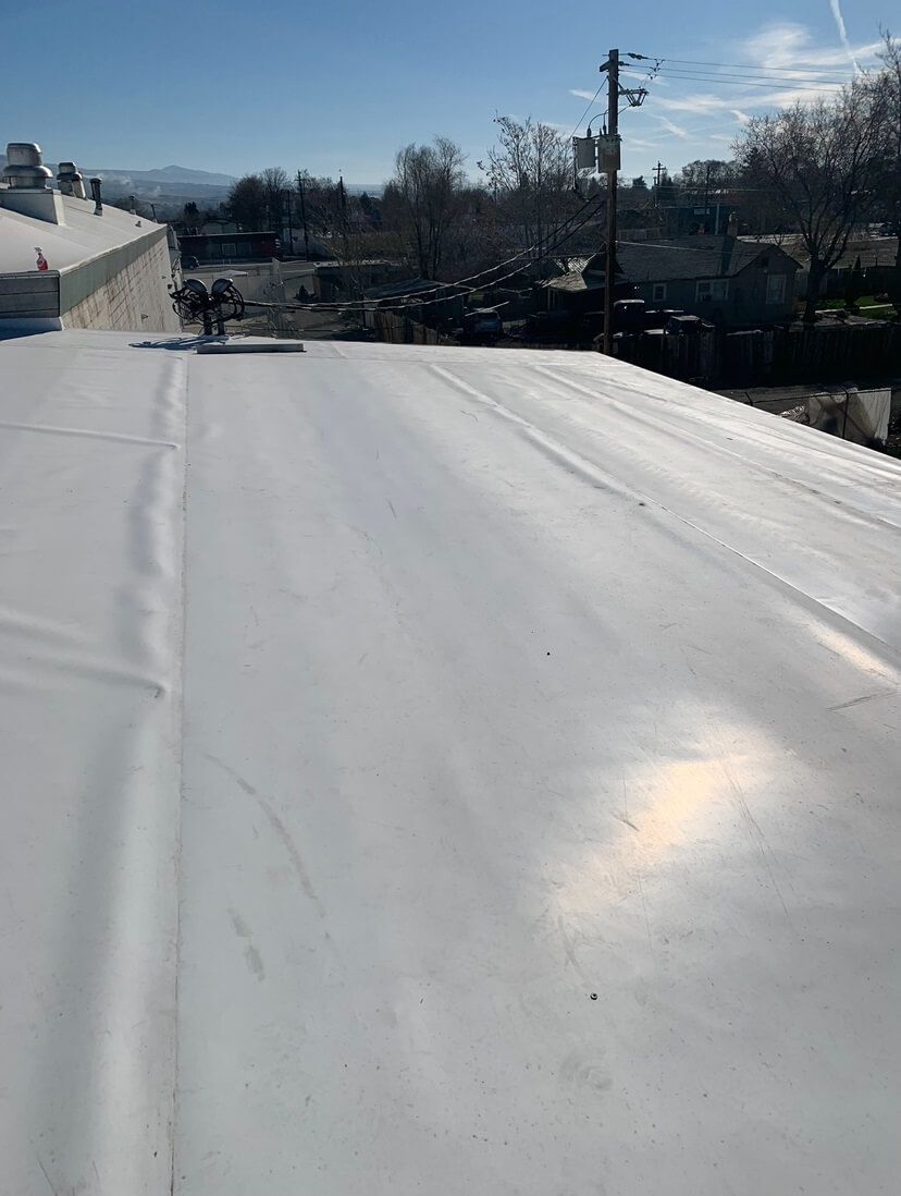 View of the completed TPO roof at Decco USA, highlighting its smooth and reflective finish.