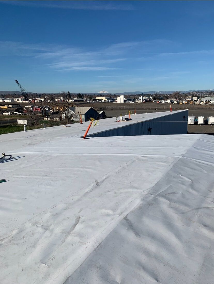 Nearly completed TPO roof at Decco USA with minor details and seam probing in progress.