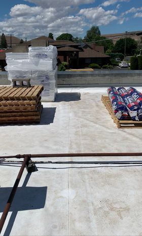 Alt Text: Roofing materials and equipment staged on the new TPO roof at Labcorp Yakima.