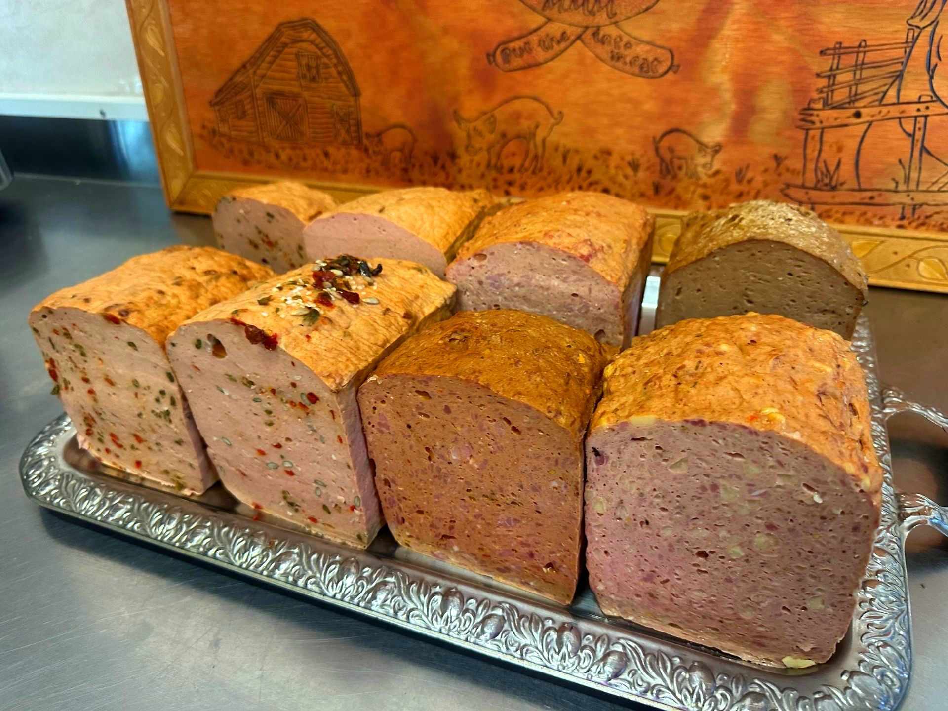 A Loaf of Meatloaf with A Slice Taken out Of It Is on A Cutting Board — Mentges Master Meats Traditional Continental Smallgoods In Taree, NSW