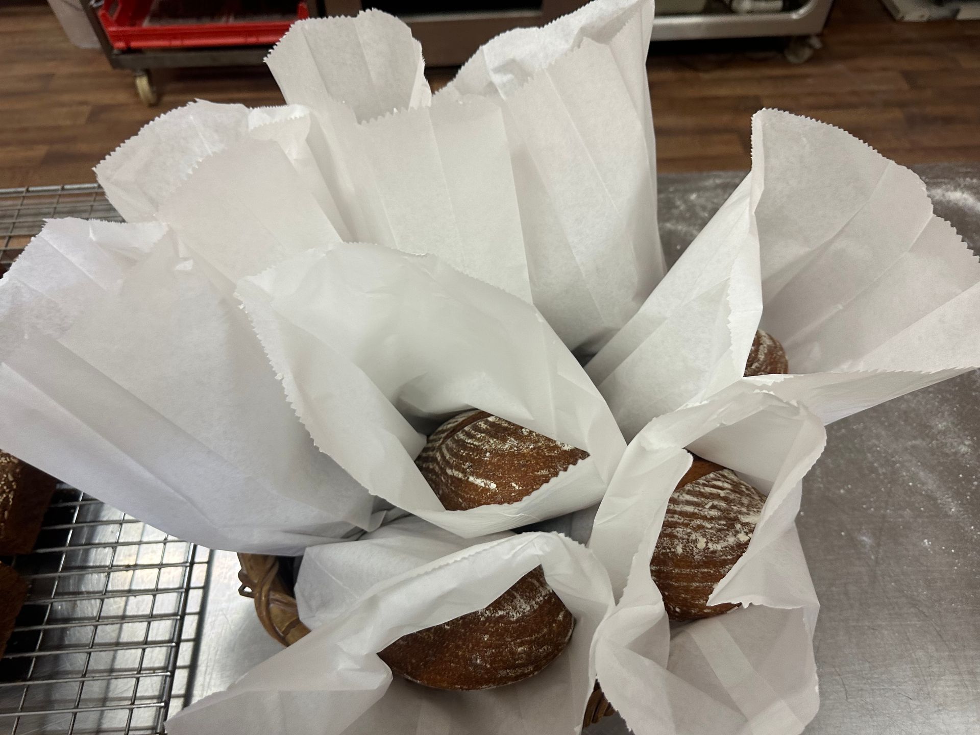 A Picture of a Man Holding a Basket of Bread — Mentges Master Meats Traditional Continental Smallgoods In Taree, NSW