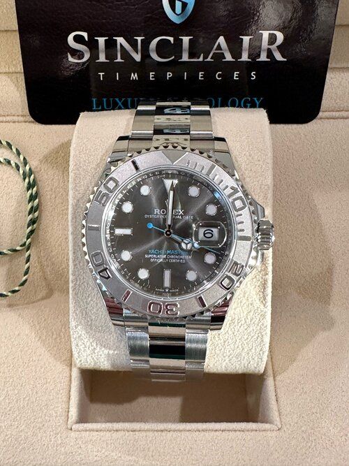 A sinclair timepieces watch is sitting on a display case