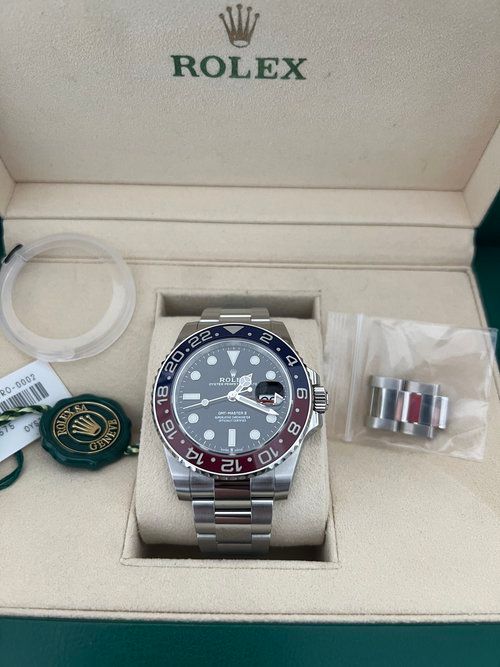 A rolex watch is sitting in a box