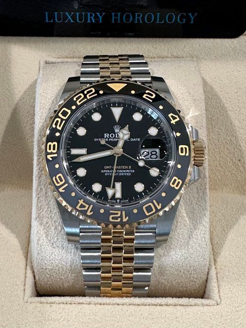 A rolex watch is sitting in a luxury horology box