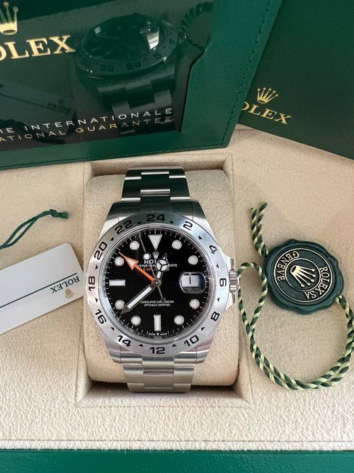A rolex watch is sitting in a box.