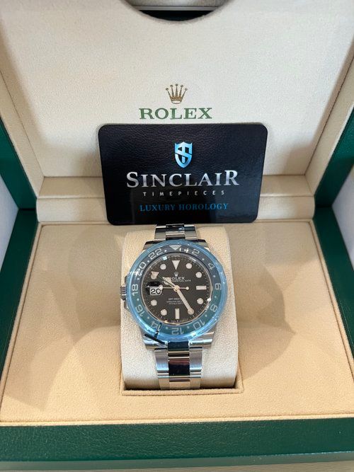 A rolex watch is in a box with a certificate