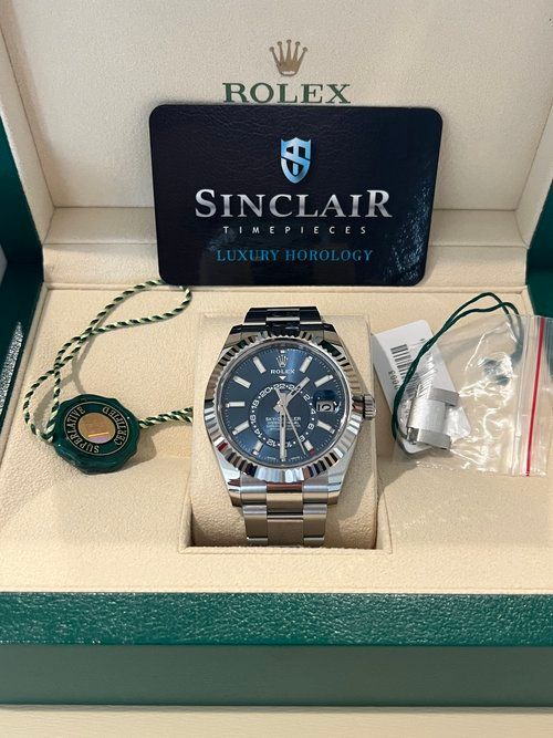 A rolex watch is in a box with a certificate.