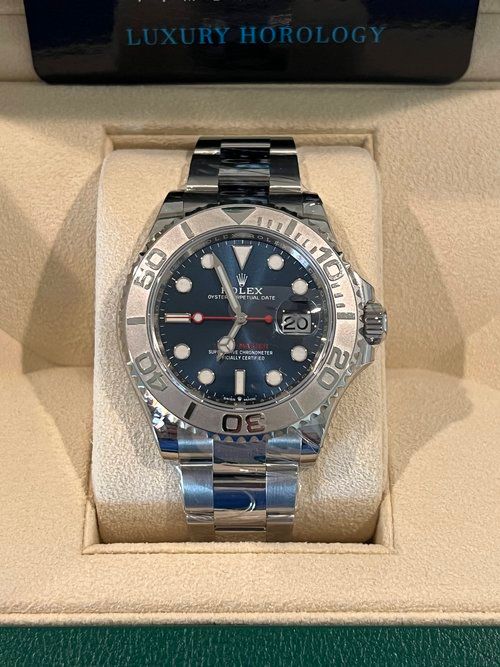 A rolex watch is sitting in a box.