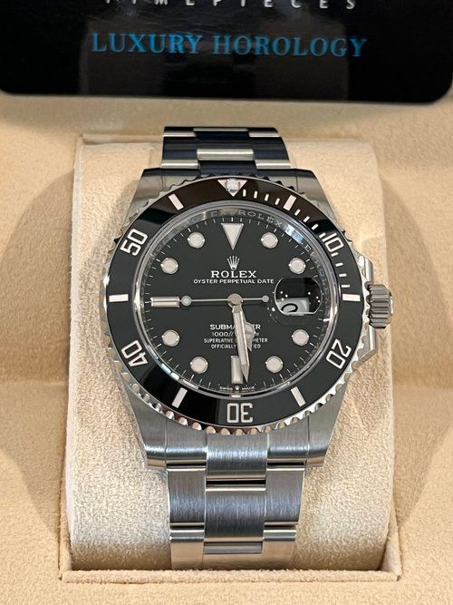 A silver rolex watch with a black face