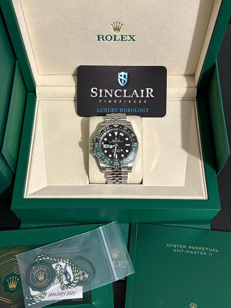 A rolex watch is in a box on a table