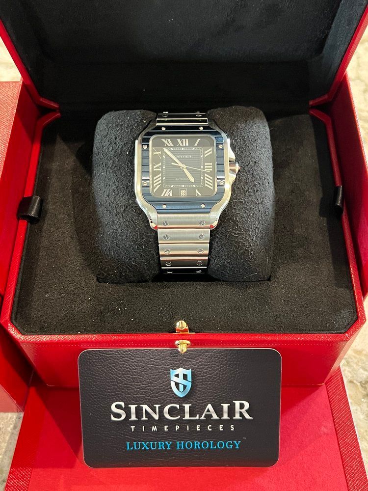 A sinclair watch is in a red box