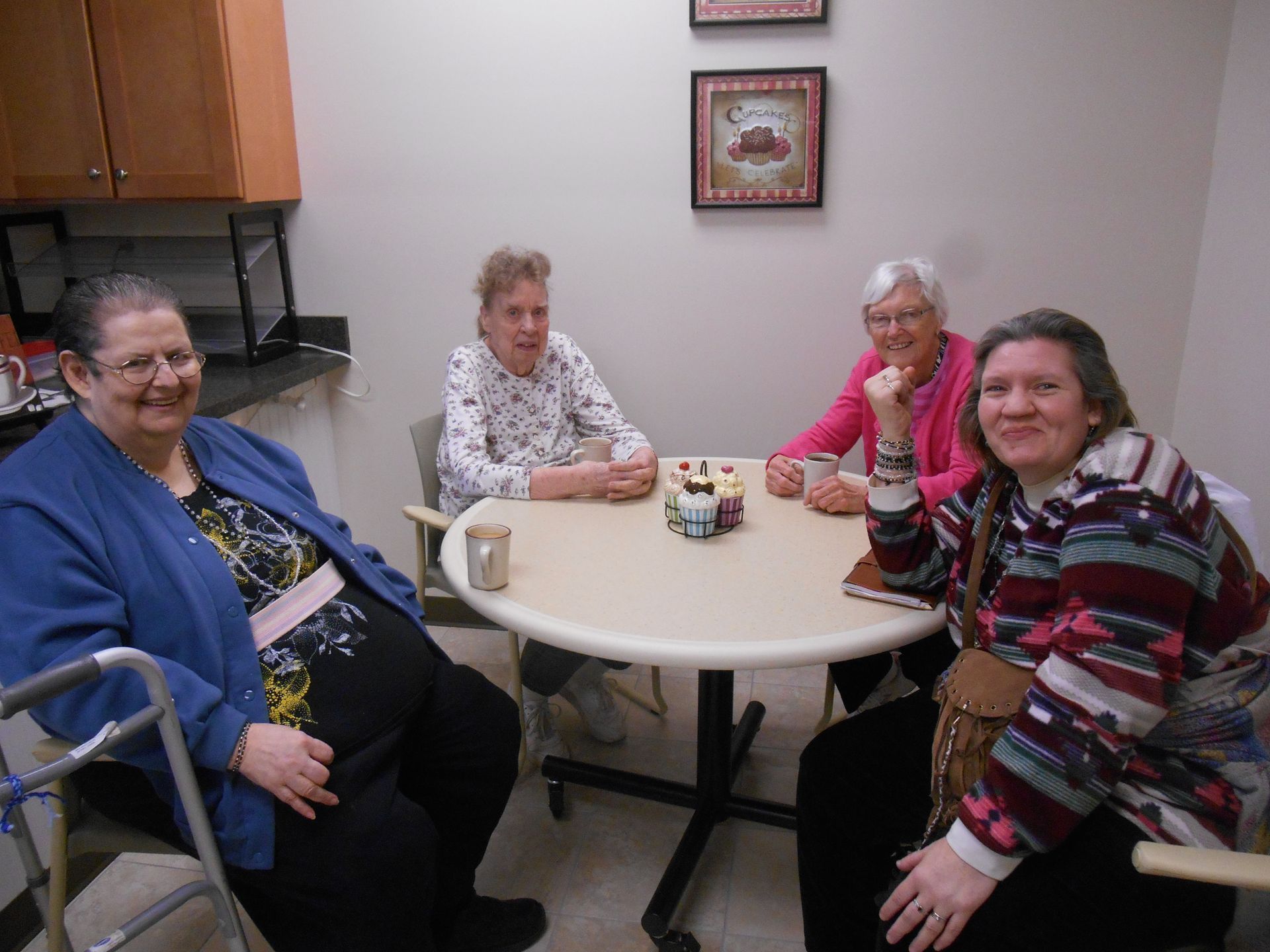 A group of elderly women are sitting around a table